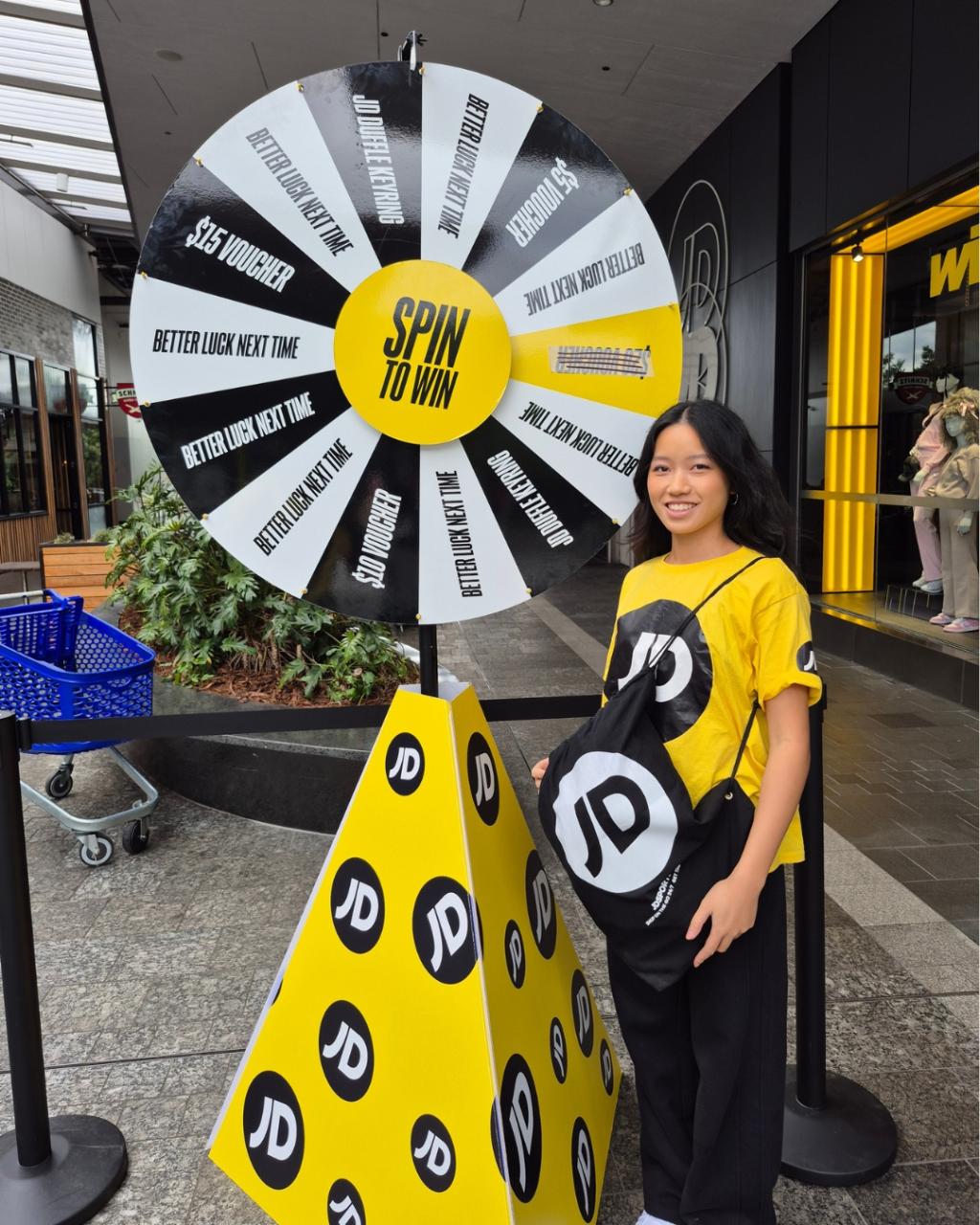 Close up of the yellow and black Coin Drop prize wheel used in the JD Sports store opening activation